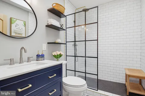 a bathroom with a toilet a sink and mirror