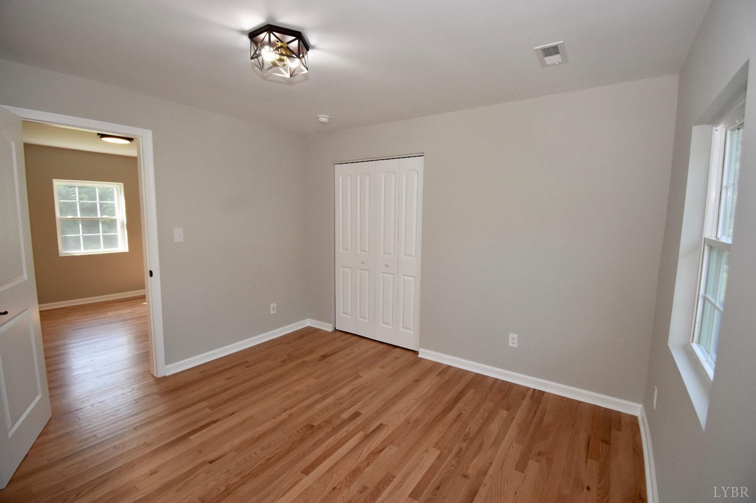 30 Sawmill Road Concord, VA 24538 - Photo 11 of 34 an empty room with wooden floor and windows
