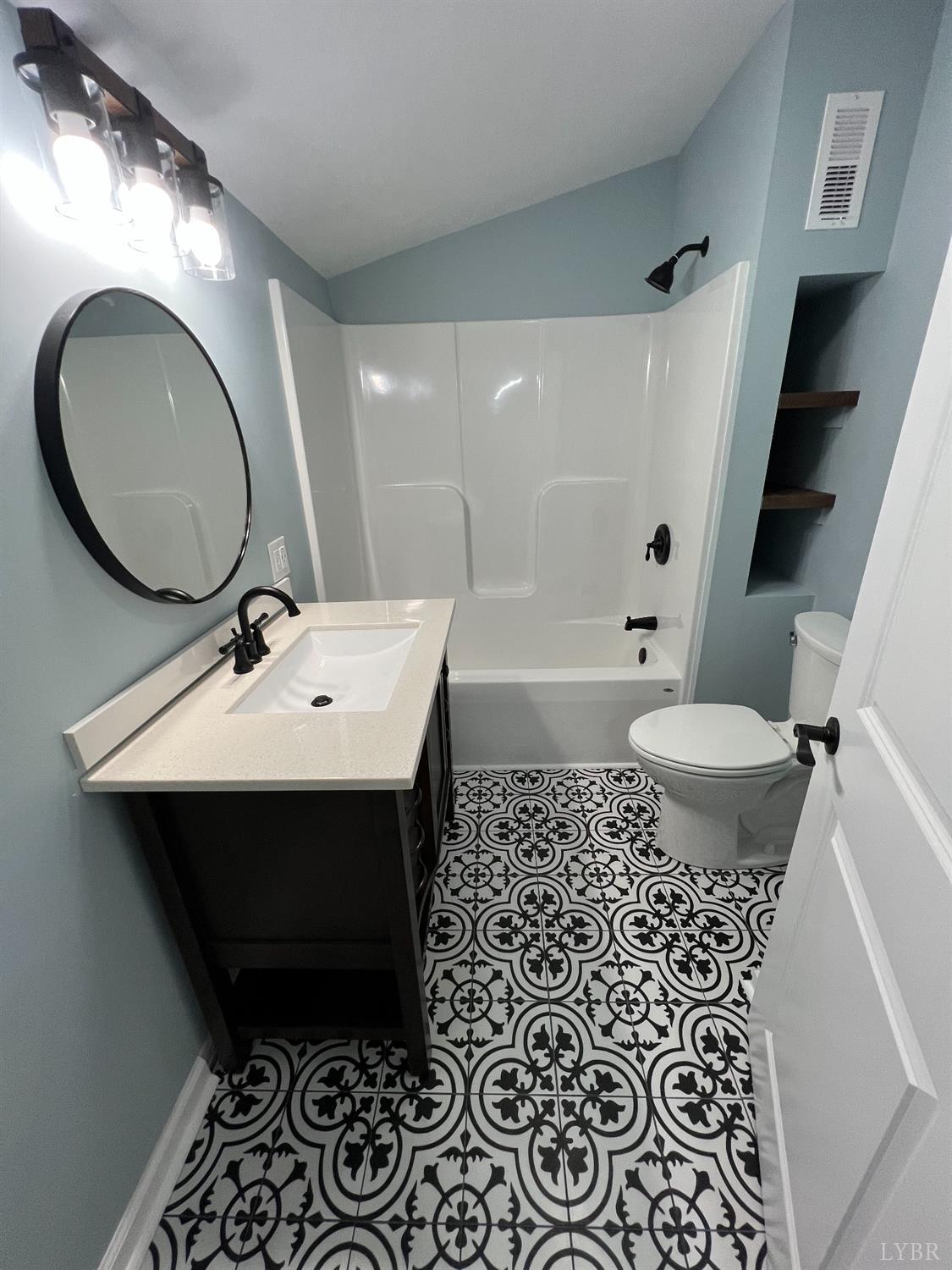 30 Sawmill Road Concord, VA 24538 - Photo 16 of 34 a bathroom with a sink toilet mirror vanity and bathtub