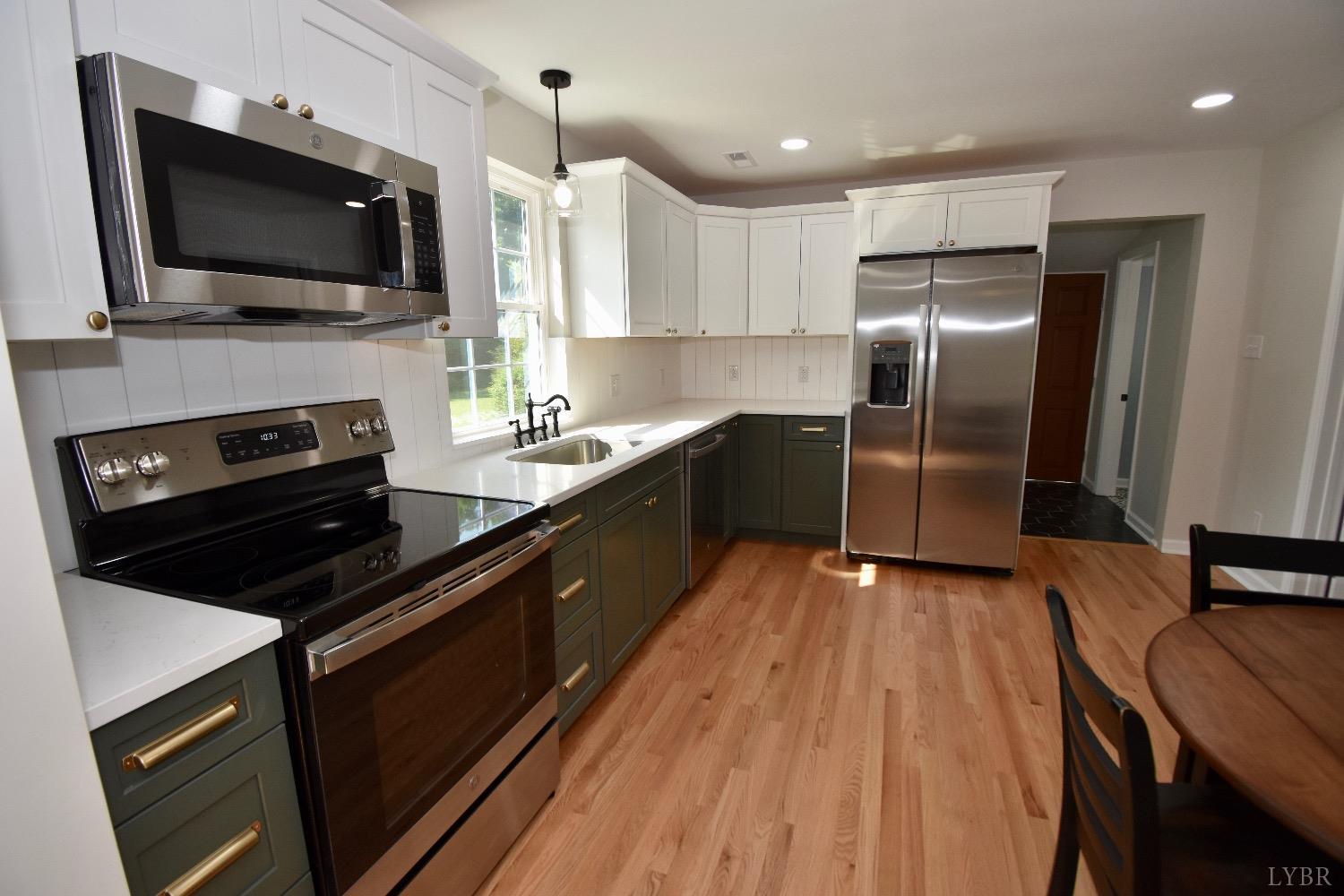 30 Sawmill Road Concord, VA 24538 - Photo 5 of 34 a kitchen with kitchen island granite countertop a sink appliances and cabinets
