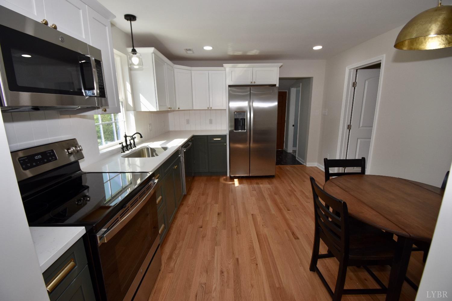 30 Sawmill Road Concord, VA 24538 - Photo 7 of 34 a kitchen with stainless steel appliances granite countertop a stove refrigerator and a microwave