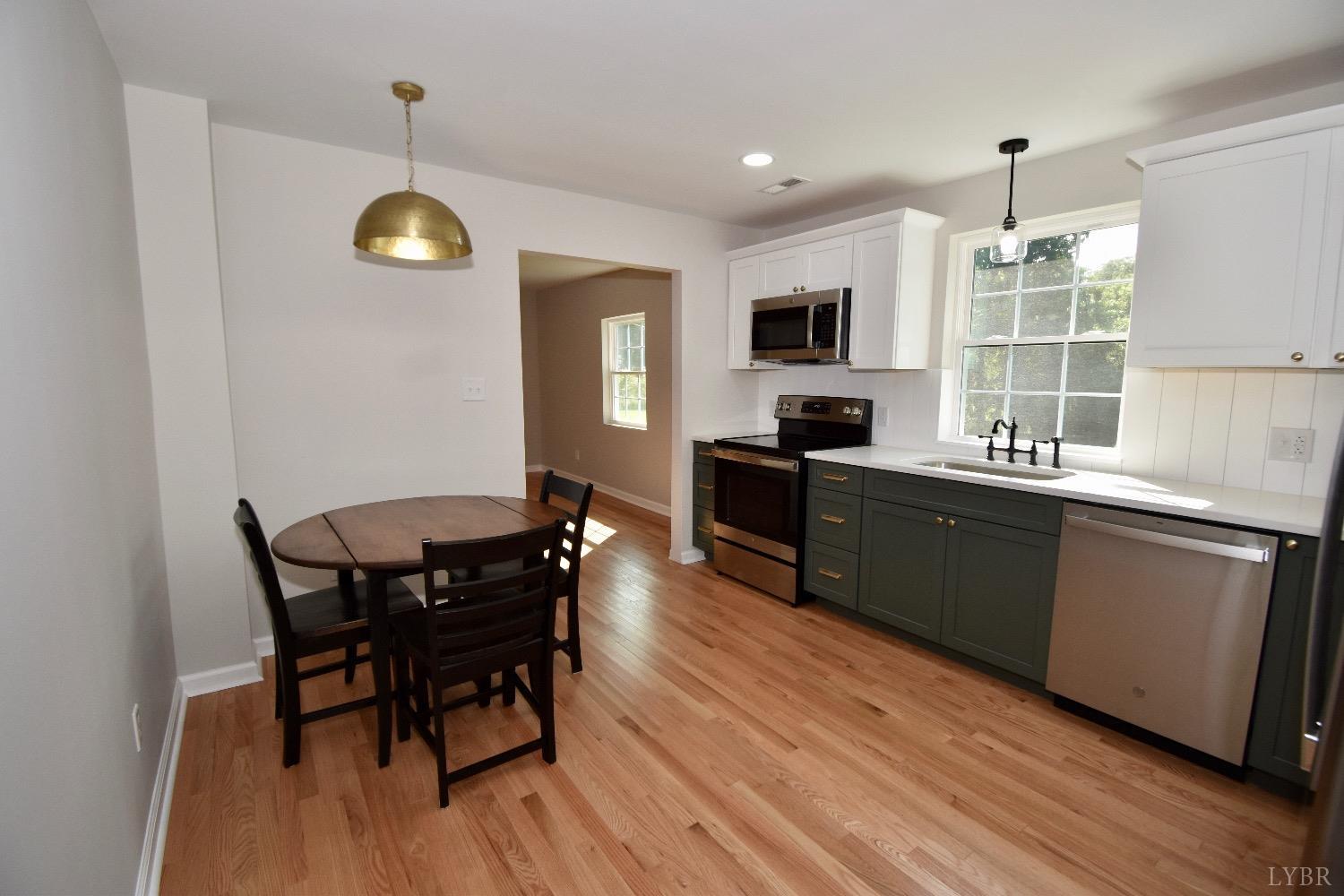 30 Sawmill Road Concord, VA 24538 - Photo 8 of 34 a kitchen with a table chairs sink and cabinets