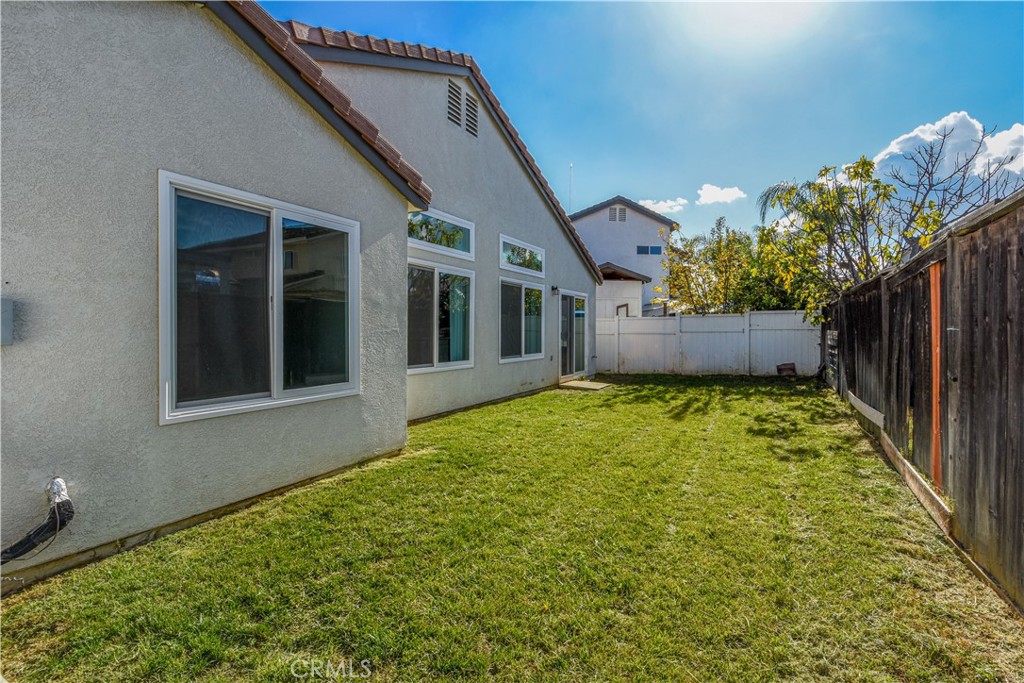 3714 Avondale Street Perris, CA 92571 - Photo 16 of 19 a view of a house with a backyard and plants