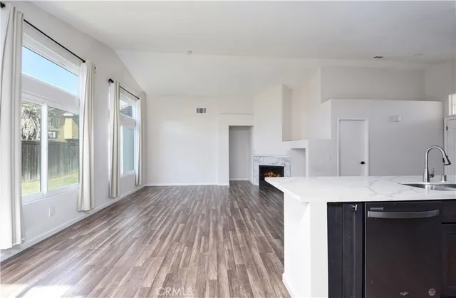 a view of kitchen and sink with cabinets