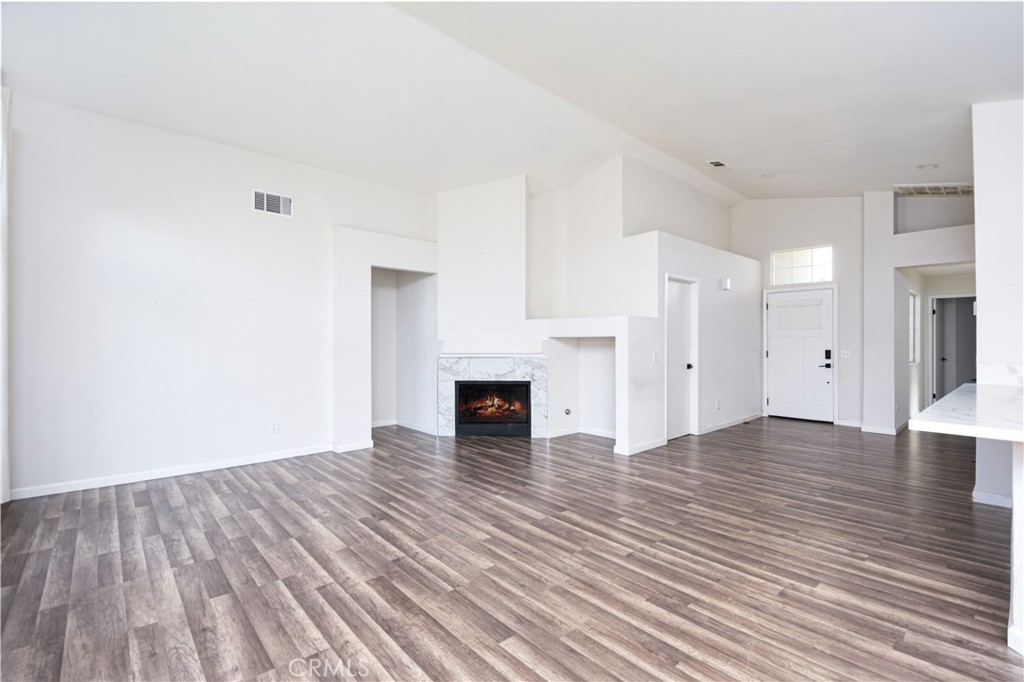 3714 Avondale Street Perris, CA 92571 - Photo 7 of 19 a view of empty room with wooden floor and fireplace