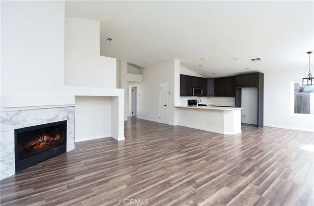 a view of kitchen with microwave and cabinets