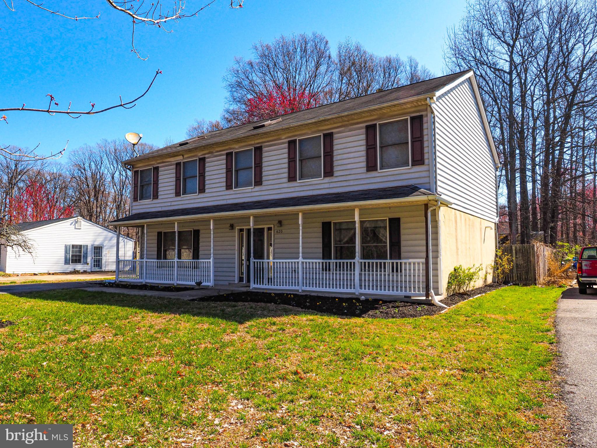 a front view of a house with a yard balcony