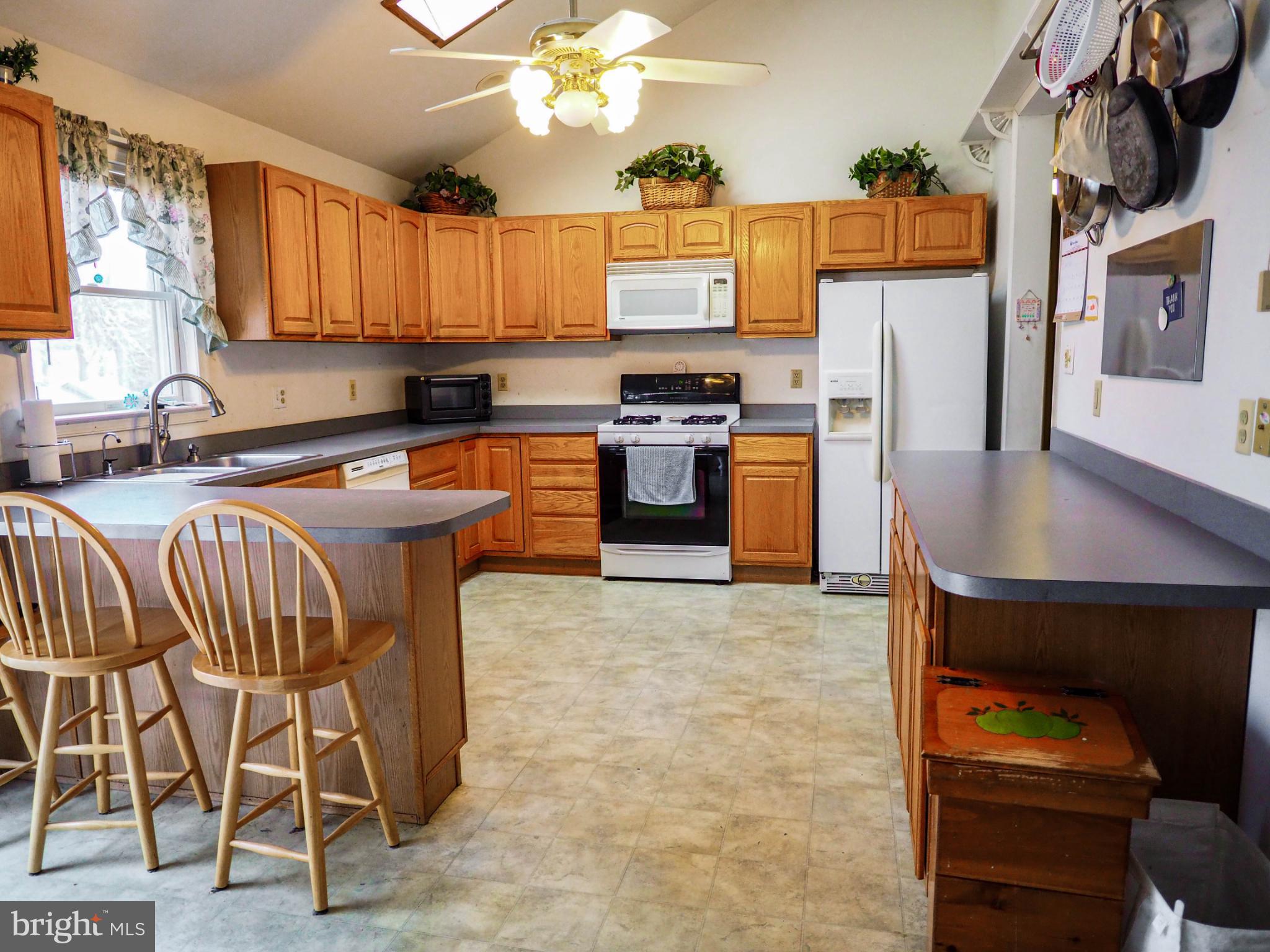 620 Old Love Point Road Stevensville, MD 21666 - Photo 23 of 45 a kitchen with stainless steel appliances granite countertop a stove a sink dishwasher and a refrigerator with wooden floor