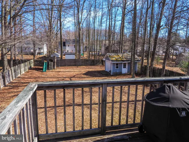 a view of swimming pool with outdoor seating and covered with trees