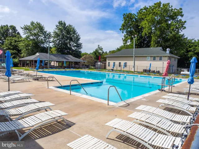 a view of a swimming pool with a outdoor seating