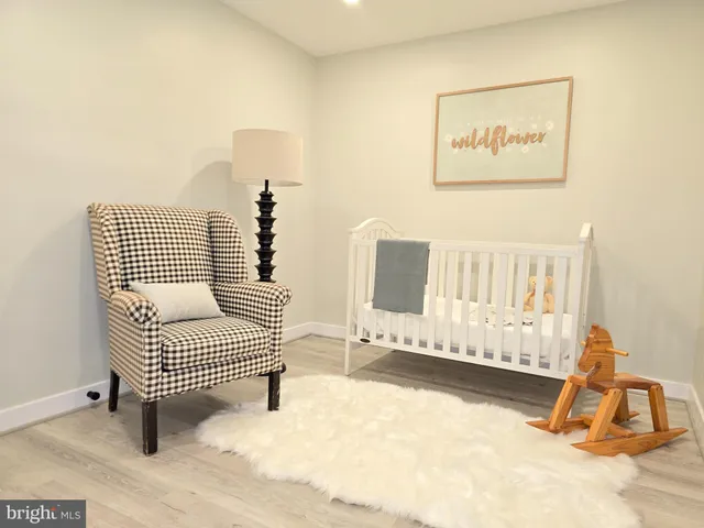 a view of a room with wooden floor and furniture