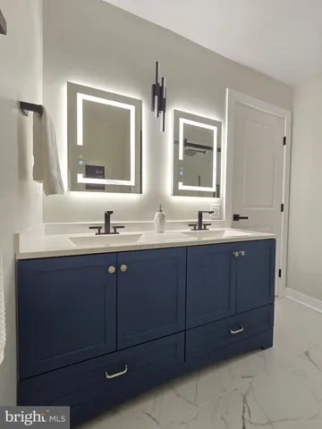 a bathroom with a double vanity sink and mirror