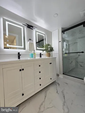 a bathroom with a double vanity sink mirror and double