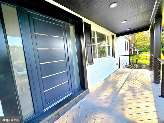 a view of hallway with stairs and wooden floor