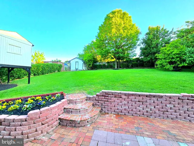 a view of a garden with a bench in garden