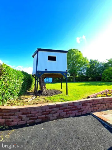 a view of a backyard with wooden fence