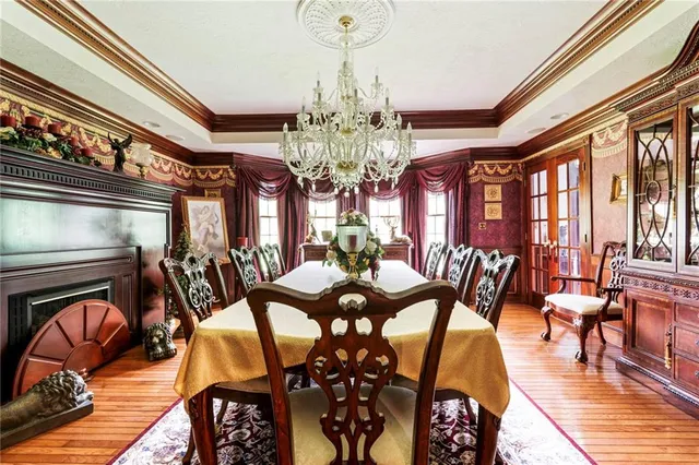 a view of a dining room with furniture wooden floor and chandelier