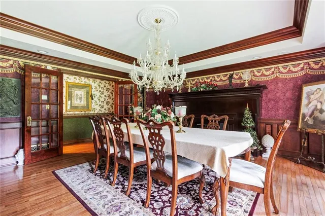 a view of a dining room with furniture wooden floor and chandelier