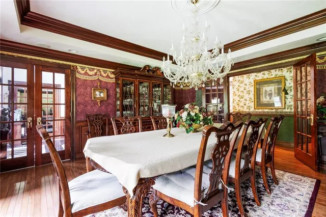 a view of a dining room with furniture wooden floor and chandelier