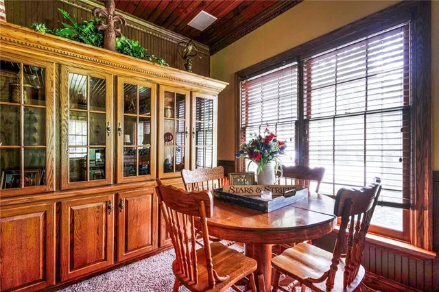 a view of a dining room with furniture large windows and wooden floor