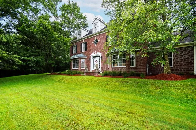 a front view of a house with a garden