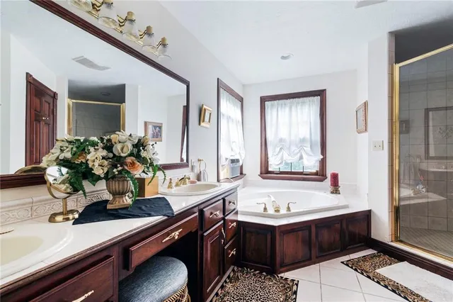 a bathroom with a tub sink and mirror