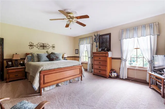 a bedroom with a bed and a tv