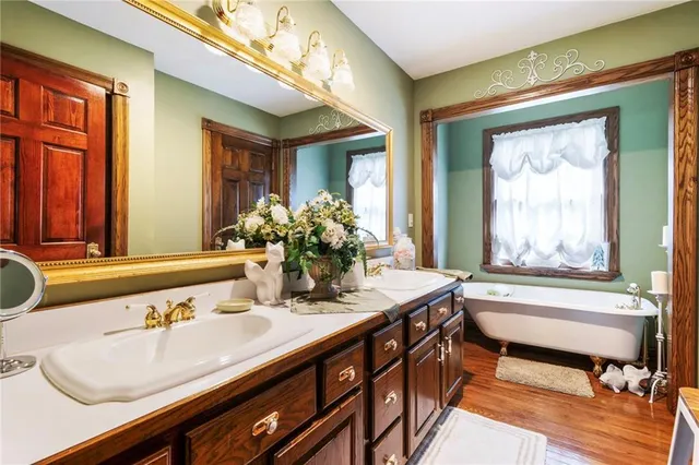 a bathroom with a granite countertop sink and a large mirror