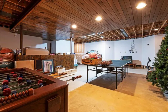 a outdoor kitchen with a stove a table and chairs