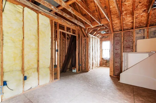 a front view of a house with swimming pool and chairs