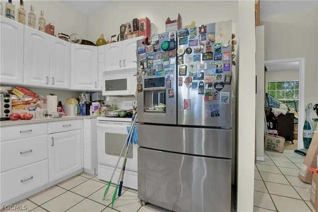 a kitchen with stainless steel appliances a refrigerator and cabinets