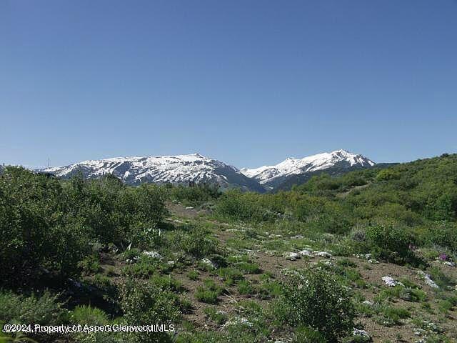0 Rabbit Way Snowmass, CO 81654 - Photo 13 of 23 a view of a large building with a mountain in the background