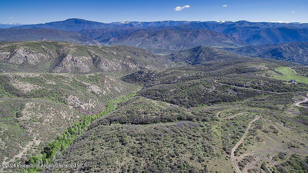 0 Rabbit Way Snowmass, CO 81654 - Photo 8 of 23 a view of a lush green field with mountains in the background