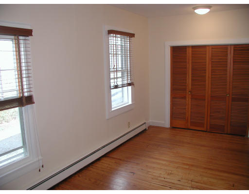 6 Decatur Street Gloucester, MA 01930 - Photo 11 of 13 an empty room with wooden floor and windows