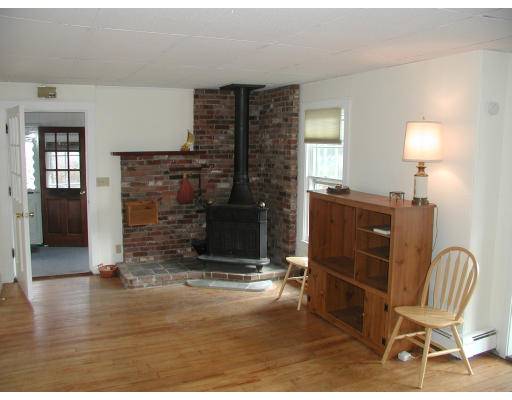 6 Decatur Street Gloucester, MA 01930 - Photo 8 of 13 a living room with furniture a wooden floor and a fireplace