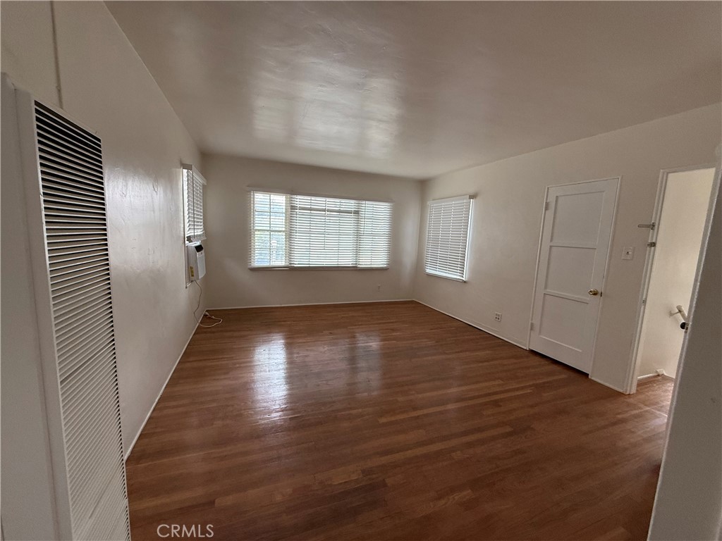 4121 4th Street Riverside, CA 92501 - Photo 12 of 25 an empty room with wooden floor and windows