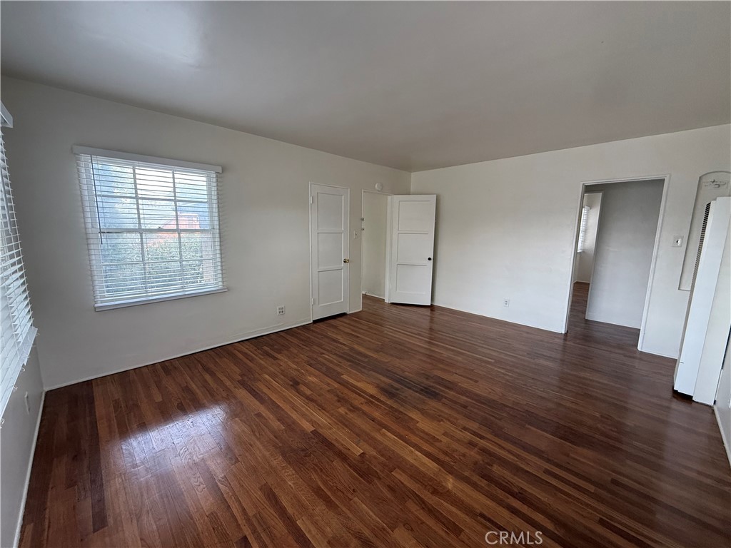 4121 4th Street Riverside, CA 92501 - Photo 17 of 25 an empty room with wooden floor and windows