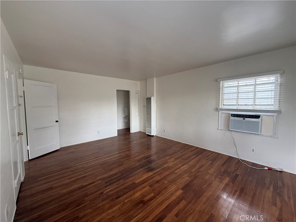 4121 4th Street Riverside, CA 92501 - Photo 18 of 25 an empty room with wooden floor and windows