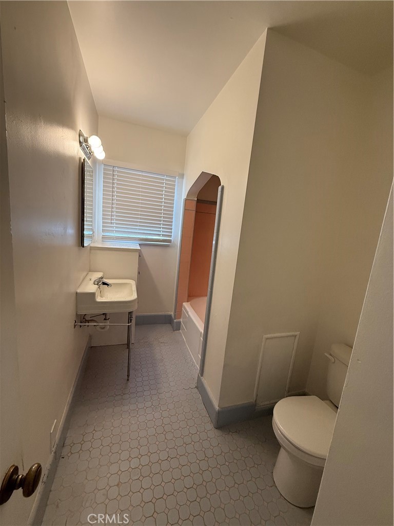 4121 4th Street Riverside, CA 92501 - Photo 8 of 25 a bathroom with a toilet and a sink