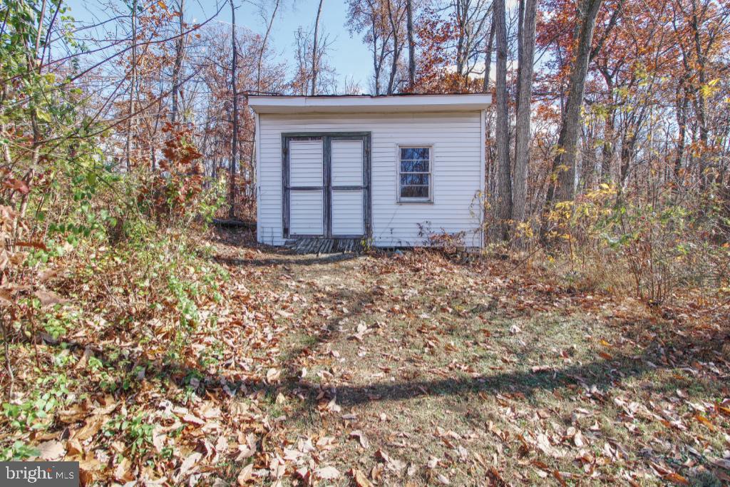 4417 Buffalo Road Mount Airy, MD 21771 - Photo 27 of 30 Charming shed nestled in autumn foliage.