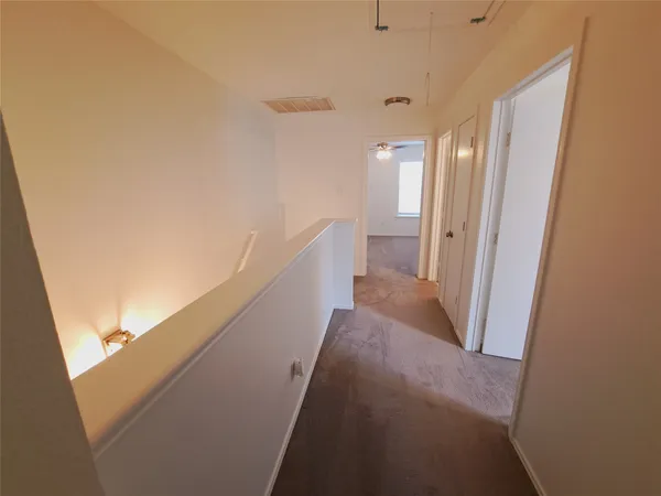 a view of a hallway with windows