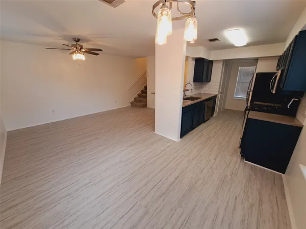 a view of a kitchen from the hallway with a sink
