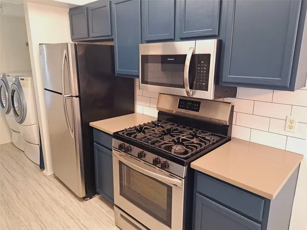 a kitchen with a stove microwave and refrigerator