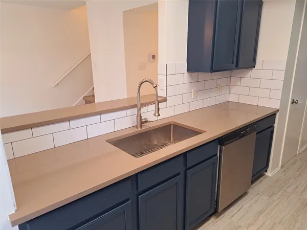 a kitchen with a sink and cabinets