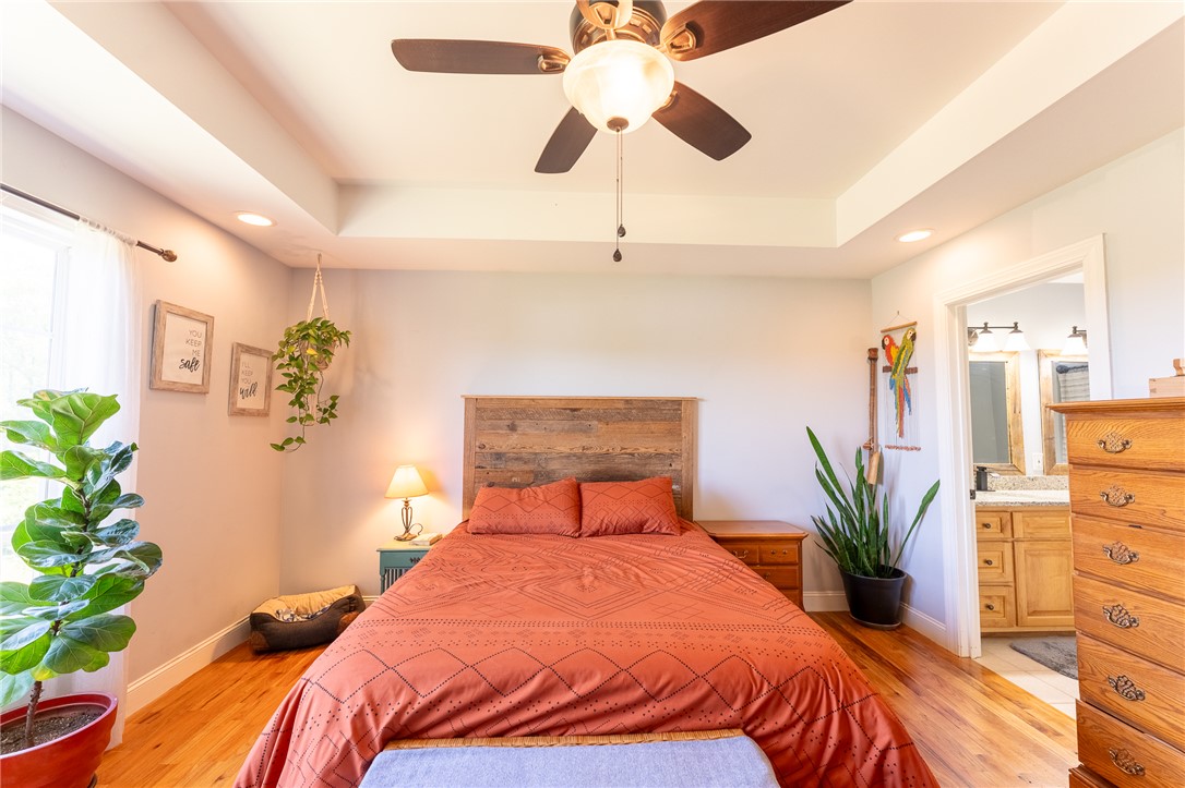 696 Mt Olivet Road Six Mile, SC 29682 - Photo 11 of 35 This tranquil bedroom features warm wood flooring and a refreshing ceiling fan for ultimate comfort.
