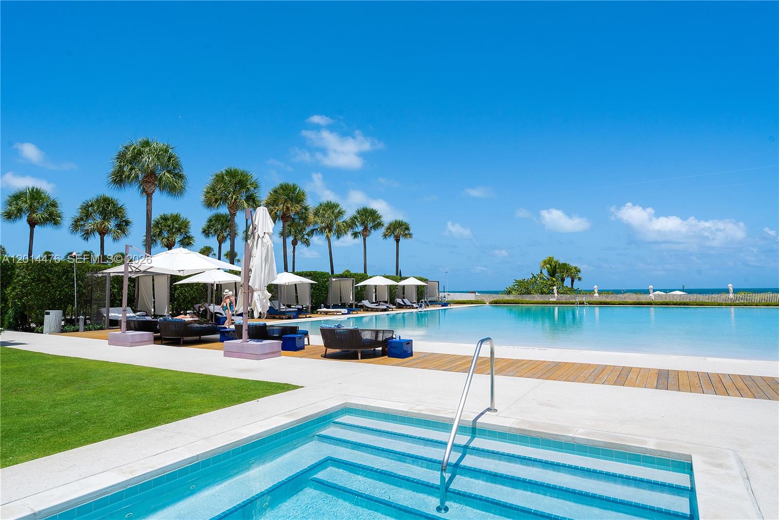 360 Ocean Drive, Unit 1106S Key Biscayne, FL 33149 - Photo 37 of 67 Poolside Amenities – The poolside setting includes shaded cabanas, lounge seating, manicured landscaping, and direct views toward the ocean. It offers a polished outdoor experience designed for relaxation and recreation.