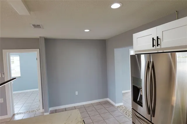an empty room with wooden floor and a window