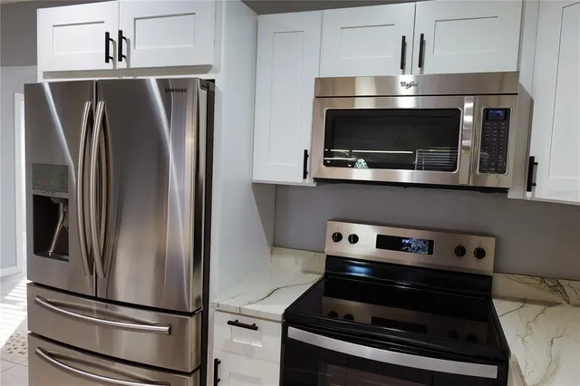 a view of an empty room with window and closet area