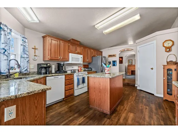 a kitchen with cabinets a sink and appliances