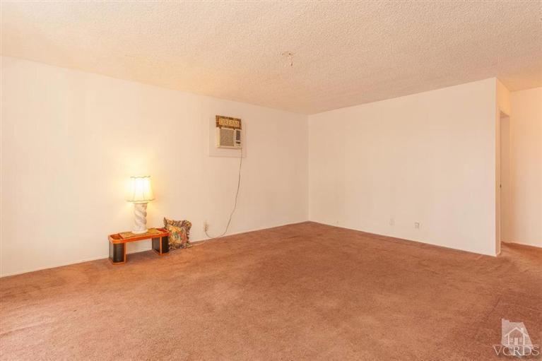 445 Charles Street Moorpark, CA 93021 - Photo 12 of 24 a bedroom with a bed and a chair